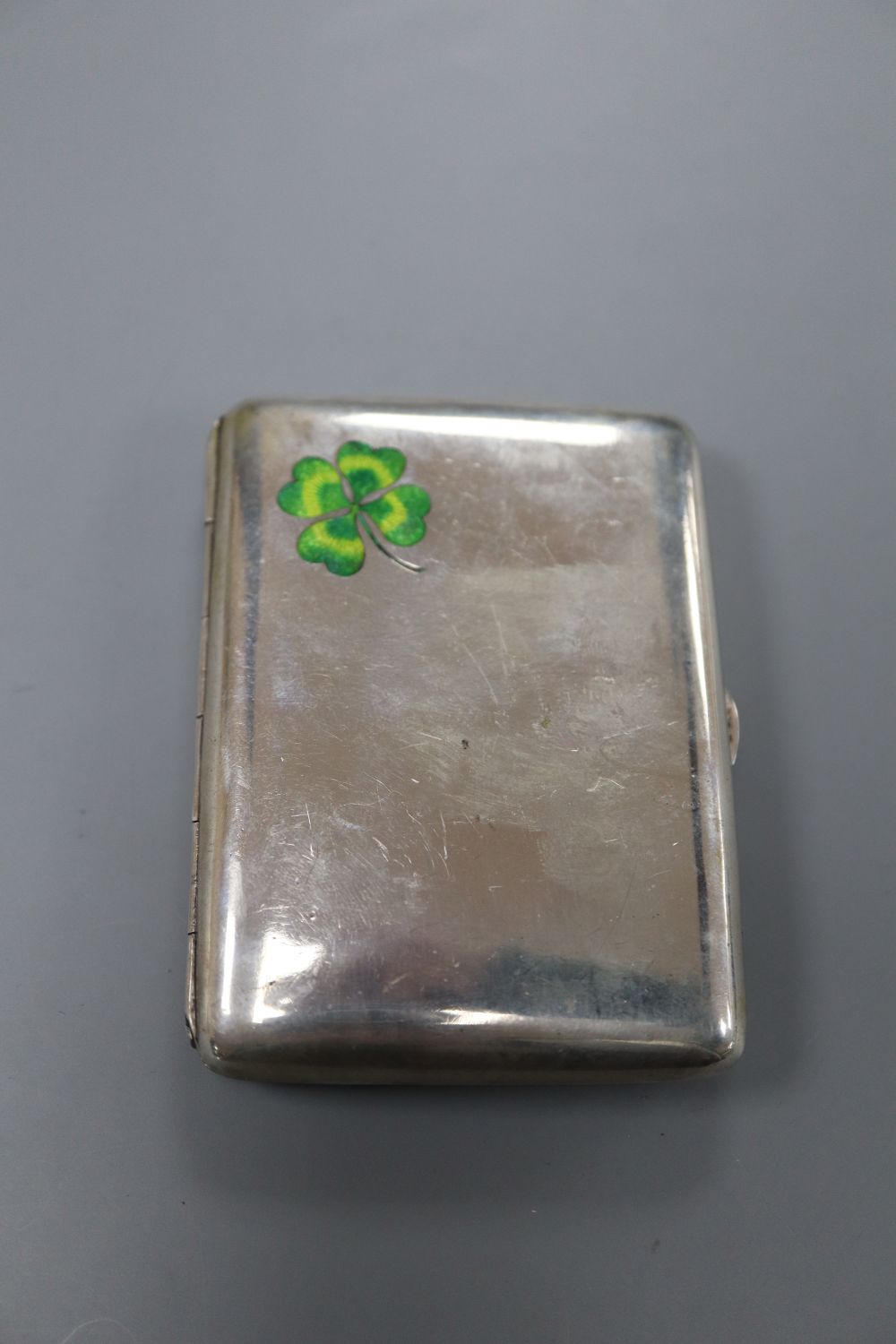 A Victorian silver handled tortoiseshell letter opener(a.f.) 25.6cm and a white metal and enamelled cigarette case, 83mm.